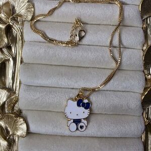 Sanrio Hello Kitty Gold Tone Metal Necklace with Blue and White Bow Pendant